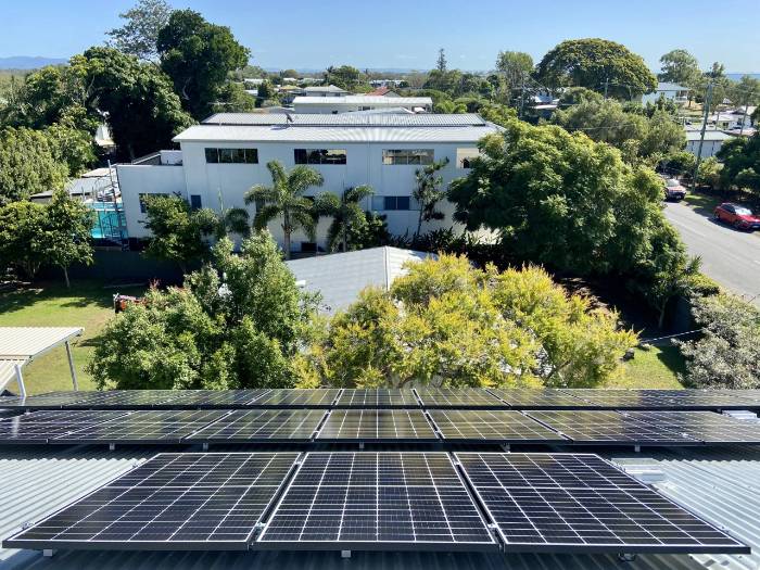 Aerial drone view of a house with an established solar panel installation
