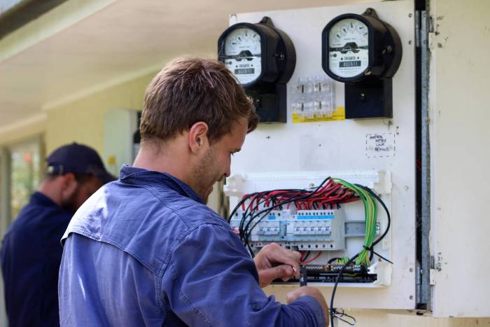 Close-up of an installer wiring a home switchboard